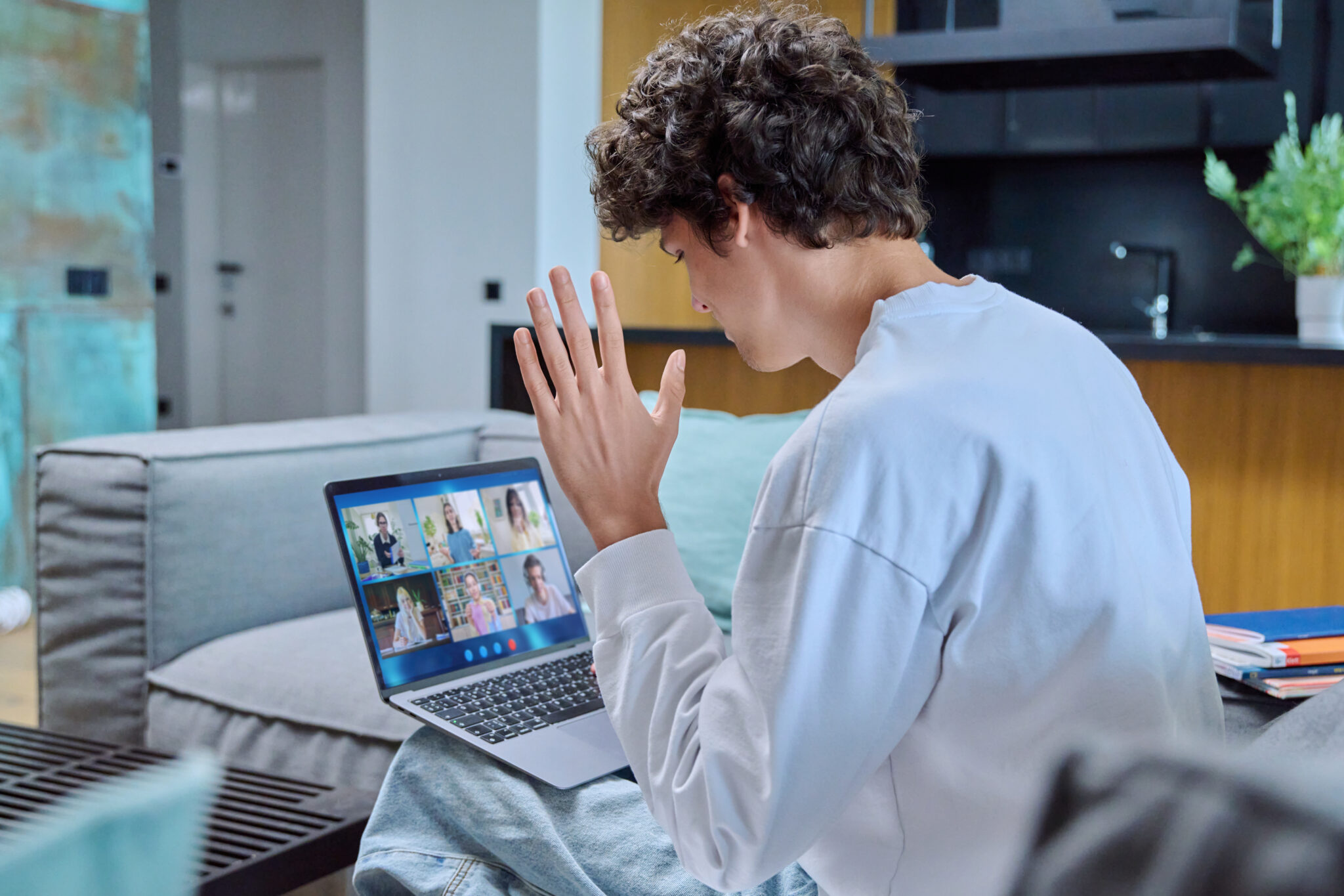 Video conference, teenage male student looking at laptop screen with group of teenagers studying remotely at home. Online lesson distance learning course. E-learning e-education technology high school